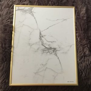 White board that is marble with a frame of gold.